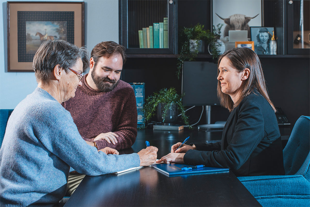 A trust administration lawyer in Rocklin and Roseville, CA helping her clients fill out legal documents