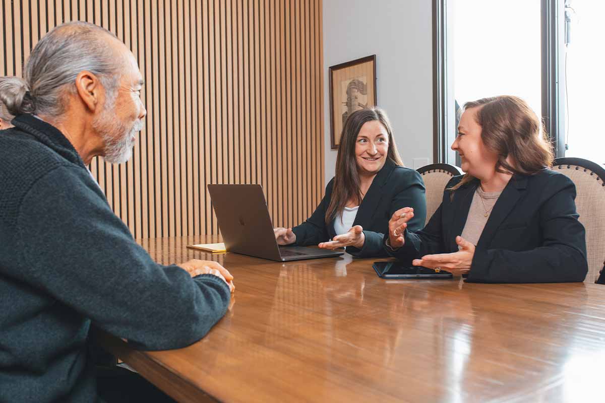 Two trust attorneys in Rocklin and Roseville meet with a client in an office.