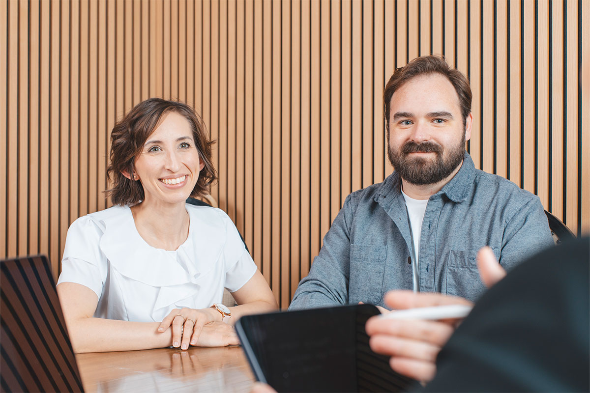 a man and woman smiling at their elder law attorney in Roseville and Rocklin, CA.